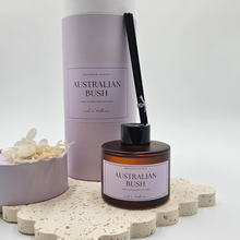 Load image into Gallery viewer, Luxury reed diffuser home fragrance in 100ml amber glass bottle with black reeds. Presented in lilac cylinder box ready for gifting. Fragrance Australian Bush