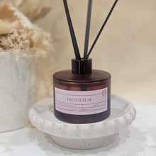 Load image into Gallery viewer, Reed diffuser with decorative container on a textured surface
