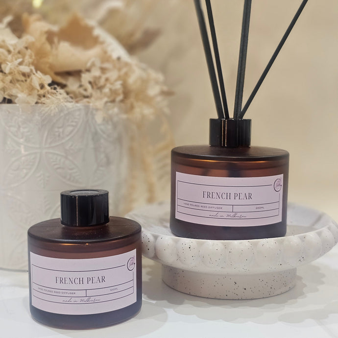 Diffuser set with reeds and bottle on a textured surface